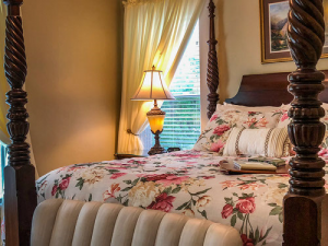 Queen sized bed in the Serenity Suite with colorful linens