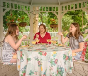 Mother and two daughters dining outside in the gazebo