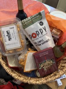 A Biltmore gift basket including snacks, wine and an ornament