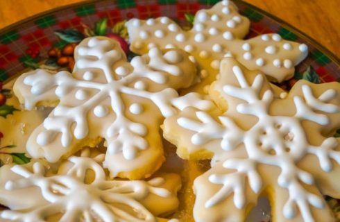snowflake shaped sugar cookies on Christmas china plate
