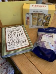 Gifts including a Blessings devotional book, Burt's bees lotions and bath bombs