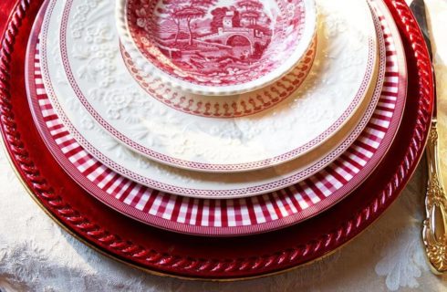 Table setting with various red and white plates and bowl