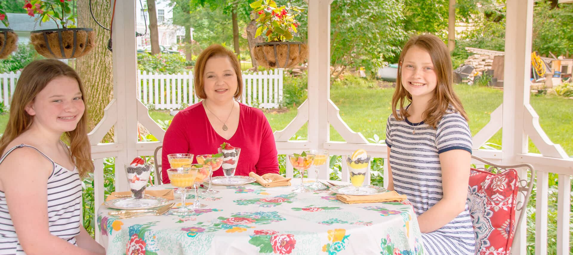 mom and two daughters have breakfast in gazebo