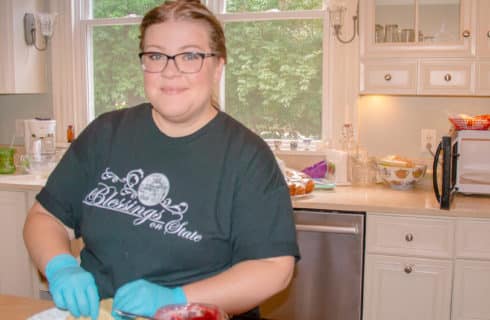 young woman prepares breakfast in kitchen