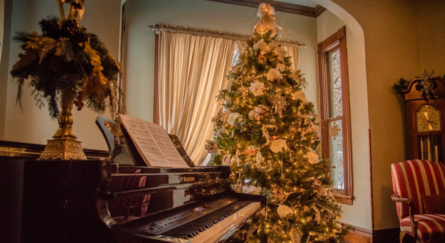 Close up view of piano with decorated Christmas tree in the background